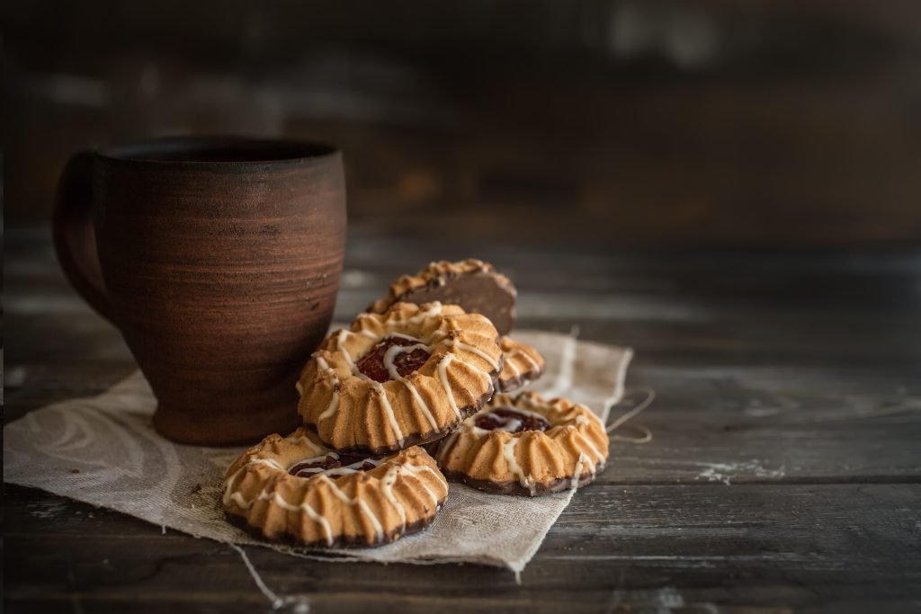 Photo of cookies and a cup on a table.