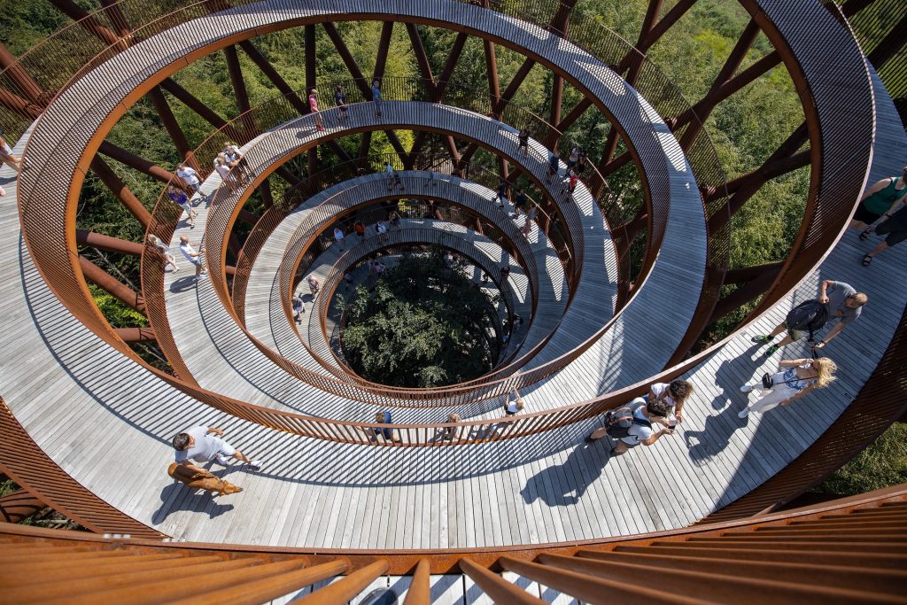 Photo of a spiraling boardwalk with people on it. 